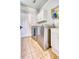 Efficient laundry room featuring stainless steel washer and dryer, tiled floor, and storage cabinets at 22678 E Lake Pl, Centennial, CO 80015
