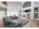 Comfortable living room with a fireplace, built-in shelves, and a large sectional sofa at 22678 E Lake Pl, Centennial, CO 80015