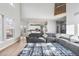 Bright living room featuring hardwood floors, a large sectional sofa, and open layout at 22678 E Lake Pl, Centennial, CO 80015