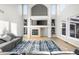 Inviting living room with a tiled fireplace, built-in shelves, and bright natural light at 22678 E Lake Pl, Centennial, CO 80015