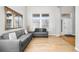 Bright living room featuring modern grey sofas, beautiful wood floors and large windows at 22678 E Lake Pl, Centennial, CO 80015