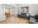 Open concept living and dining rooms with wood floors and white pillars offer a modern aesthetic at 22678 E Lake Pl, Centennial, CO 80015