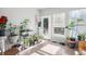 Bright sunroom with lots of windows, tile floor, potted plants, and access to backyard at 22678 E Lake Pl, Centennial, CO 80015