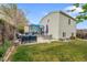 Lush backyard with a stone patio, seating area, and green lawn, offering a serene outdoor space at 4856 S Quintero Cir, Aurora, CO 80015