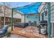 Inviting backyard patio featuring a hot tub, grill, and seating area under a blue canopy, perfect for relaxation at 4856 S Quintero Cir, Aurora, CO 80015