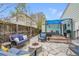 Beautiful backyard with stone patio, fire pit, comfortable seating, and a covered hot tub, ideal for outdoor living at 4856 S Quintero Cir, Aurora, CO 80015