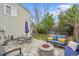 Spacious backyard featuring a stone patio, fire pit, comfortable seating, and well-maintained lawn at 4856 S Quintero Cir, Aurora, CO 80015