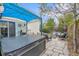Relaxing backyard with a hot tub, stone patio, outdoor seating, and a grill, perfect for entertaining guests at 4856 S Quintero Cir, Aurora, CO 80015