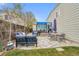 Expansive backyard with a stone patio, seating areas, covered hot tub, and lush green lawn, perfect for outdoor enjoyment at 4856 S Quintero Cir, Aurora, CO 80015