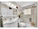 Bright and clean bathroom with glass shower doors and marble wall tiles at 4856 S Quintero Cir, Aurora, CO 80015