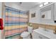 Bathroom with colorful shower curtain and tile surround at 4856 S Quintero Cir, Aurora, CO 80015