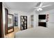 Bright bedroom with closet and shelves, ceiling fan, and a view into the laundry room at 4856 S Quintero Cir, Aurora, CO 80015