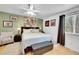 Comfortable bedroom with light green walls, ceiling fan, and a decorative painting above the headboard at 4856 S Quintero Cir, Aurora, CO 80015