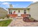 Charming home with brick accents, a colorful walkway, and a manicured front yard at 4856 S Quintero Cir, Aurora, CO 80015