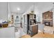 Modern kitchen with stainless steel appliances and an open view to the living room at 4856 S Quintero Cir, Aurora, CO 80015