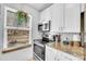 Bright kitchen featuring stainless steel appliances and granite countertops at 4856 S Quintero Cir, Aurora, CO 80015