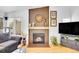 Bright living room with fireplace, hardwood floors, and stylish decor at 4856 S Quintero Cir, Aurora, CO 80015