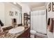 Well-lit bathroom with a dark wood vanity, marble countertop, and shower with curtain at 9182 Ridgegate Pkwy, Lone Tree, CO 80124