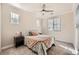 Cozy bedroom with ceiling fan, carpeted floors, and bright natural light from multiple windows at 9182 Ridgegate Pkwy, Lone Tree, CO 80124