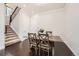 Dining room featuring a rustic wooden table and staircase at 9182 Ridgegate Pkwy, Lone Tree, CO 80124