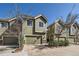 Charming townhome exterior with green siding and attached garage, providing curb appeal at 9182 Ridgegate Pkwy, Lone Tree, CO 80124