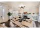 Bright living room with a cozy fireplace, built-in shelving, and stylish decor at 9182 Ridgegate Pkwy, Lone Tree, CO 80124