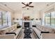 Bright living room with a cozy fireplace, built-in shelving, and stylish decor at 9182 Ridgegate Pkwy, Lone Tree, CO 80124