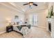 Serene main bedroom with tray ceiling, fireplace, and French doors opening to a balcony at 9182 Ridgegate Pkwy, Lone Tree, CO 80124