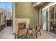 Outdoor patio featuring a fireplace, string lights, and seating, great for relaxing at 9182 Ridgegate Pkwy, Lone Tree, CO 80124
