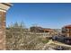 Wide view of a community building surrounded by greenery and a street at 9182 Ridgegate Pkwy, Lone Tree, CO 80124