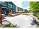 Backyard with stone patio, deck area, and lush landscaping at 1941 Fox Fire St, Highlands Ranch, CO 80129