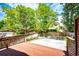 Back yard featuring patio and yard area, surrounded by a wood fence and mature trees at 1941 Fox Fire St, Highlands Ranch, CO 80129