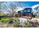 Exterior view of blue two-story home featuring a beautiful backyard with stone patio at 1941 Fox Fire St, Highlands Ranch, CO 80129