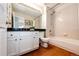 Bright bathroom with tub and shower combo and dark countertops at 1941 Fox Fire St, Highlands Ranch, CO 80129