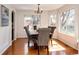 Cozy dining room features hardwood floors, multiple windows, and stylish chandelier for elegant meals at 1941 Fox Fire St, Highlands Ranch, CO 80129