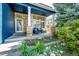 Inviting front porch with stone pillars, seating area, and lush landscaping creating a welcoming entrance at 1941 Fox Fire St, Highlands Ranch, CO 80129