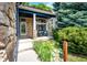 Inviting front porch with stone accents, comfortable seating, and a well-manicured garden enhancing the curb appeal at 1941 Fox Fire St, Highlands Ranch, CO 80129