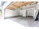 Well lit two car garage with neutral paint, storage cabinets, and concrete floors at 1941 Fox Fire St, Highlands Ranch, CO 80129