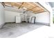 Spacious two car garage featuring ample storage cabinets and concrete floors at 1941 Fox Fire St, Highlands Ranch, CO 80129