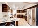 Modern kitchen with stainless steel appliances, granite countertops, and ample cabinet space with tiled floors at 1941 Fox Fire St, Highlands Ranch, CO 80129