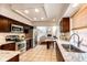 Modern kitchen with stainless steel appliances, granite countertops, and ample cabinet space, open to the living area at 1941 Fox Fire St, Highlands Ranch, CO 80129