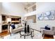 Cozy living room open to the kitchen boasts hardwood floors and plenty of natural light at 1941 Fox Fire St, Highlands Ranch, CO 80129