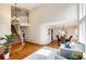 Spacious living room with hardwood floors, staircase, chandelier and abundant natural light, perfect for entertaining at 1941 Fox Fire St, Highlands Ranch, CO 80129