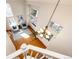 An overhead view of a living room showcasing a light fixture, a staircase, and the entry way at 1941 Fox Fire St, Highlands Ranch, CO 80129