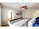 Comfortable main bedroom features a ceiling fan, neutral decor, and ensuite bath access at 1941 Fox Fire St, Highlands Ranch, CO 80129