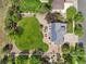 Aerial view of a home with a large, well-manicured backyard, patio, and solar panels on the roof at 21434 E Greenwood Pl, Aurora, CO 80013
