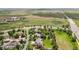 Neighborhood aerial shot showcasing a home with a large backyard, green space, and nearby roads at 21434 E Greenwood Pl, Aurora, CO 80013