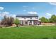 Expansive backyard with a well-kept lawn and mature trees offers a serene outdoor space at 21434 E Greenwood Pl, Aurora, CO 80013