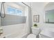 Bright bathroom with a shower-tub combo, a window with great sky-views, and modern fixtures at 21434 E Greenwood Pl, Aurora, CO 80013