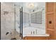 Stylish bathroom with a corner soaking tub, marble tile, modern fixtures, and natural light at 21434 E Greenwood Pl, Aurora, CO 80013